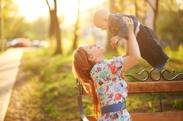 Obraz premium Beautiful young woman with baby boy