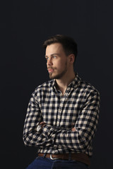 Handsome brunette man over black wall