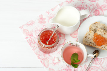 Watermelon Jam, Herbal Tea, Marshmallows. White Wooden Table