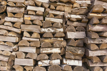 Stack of firewood of birch. Closeup. As background or texture