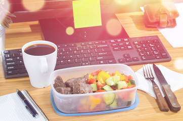 homemade lunch box at modern stylish work place, view from above