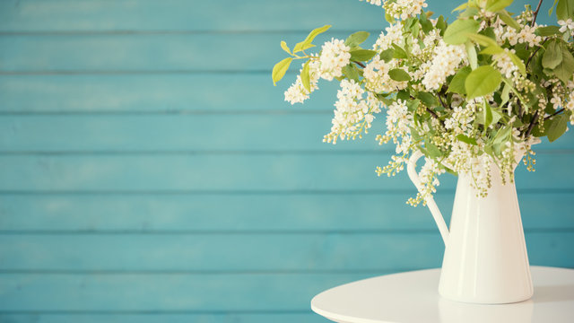 Fototapeta Beautiful white flowers in a vase, on blue wooden background
