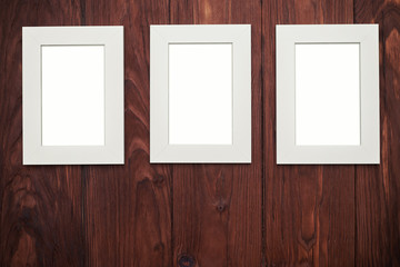 Three vertical frames on brown wooden desk