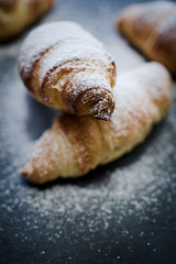 Homemade puff-pastry butter croissants and powdered sugar
