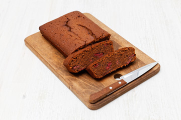 Homemade cake with red wine and cherry on wooden table