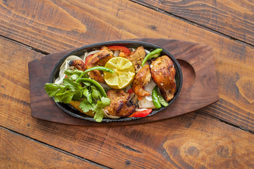 Food grilled chicken pieces on a dish