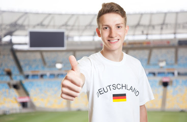 Deutscher Fussball Fan im Stadion zeigt Daumen hoch