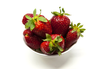 Fresh strawberries on a plate on white background
