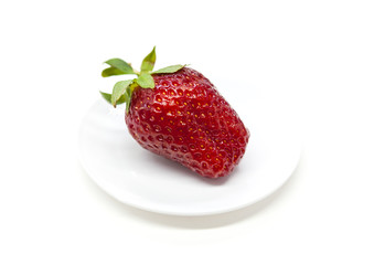 Fresh strawberry on a plate isolated on white background