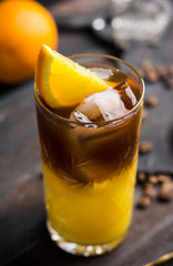 Orange and coffee cocktail on the wooden background. Shallow depth of field.