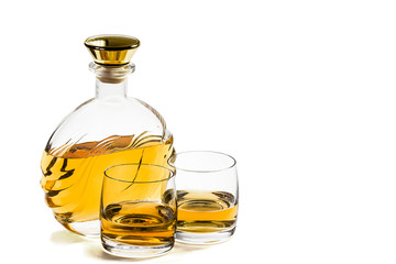 Bottle and two glass of whiskey on white background
