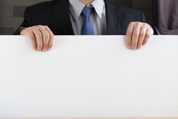 Hand of businessman showing white paper