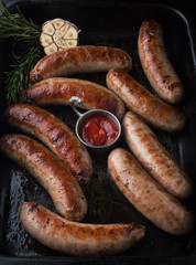 Grilled sausages on the grill with rosemary and garlic - 108862086