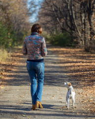 Fototapeta premium woman walking with a dog