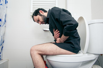 man having problems in the toilet