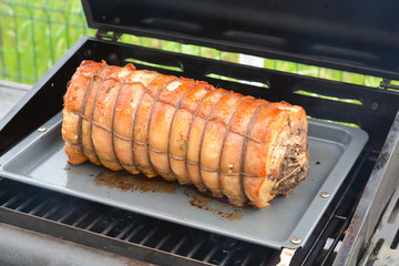 Cooked roast of pork or italian porchetta recipe on a grill