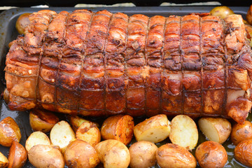 Cooked roast of pork or Italian porchetta recipe on a grill