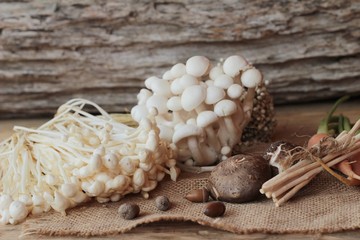Mushrooms and vegetables on wood background.