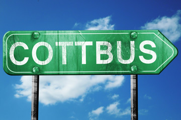 Cottbus road sign, vintage green with clouds background