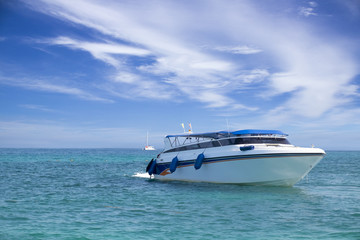 Fototapeta na wymiar speed boat in tropical sea with blusky