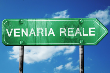 Venaria reale road sign, vintage green with clouds background