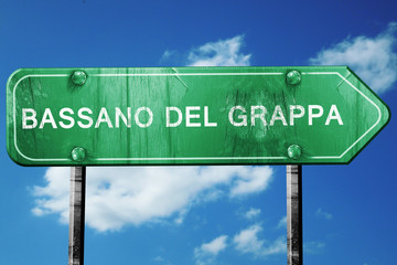 Bassano del grappa road sign, vintage green with clouds backgrou