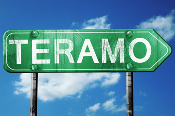 Teramo road sign, vintage green with clouds background