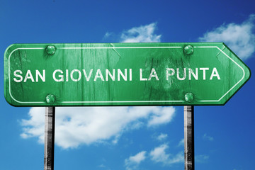 San giovanni la punta road sign, vintage green with clouds backg