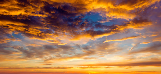 Setting summer sun with fluffy clouds