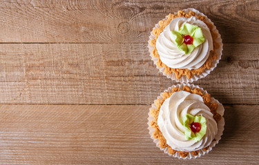 Pink cupcakes on wooden background