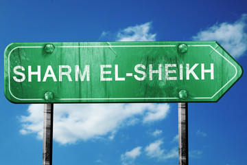 sharm el-sheikh road sign, vintage green with clouds background