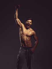 Fototapeta na wymiar Athletic young man posing, studio shot