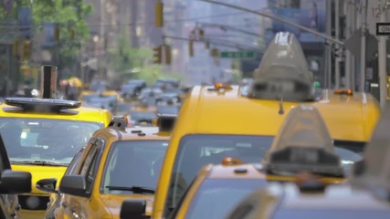 Cars vehicles taxi cabs rush hour congested heavy street traffic Manhattan NYC sunny summer day New York City
