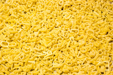 Noodle letters on wooden background