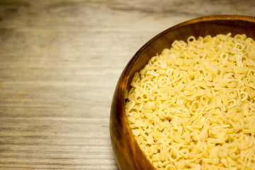 Noodle letters on wooden background