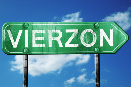 vierzon road sign, vintage green with clouds background