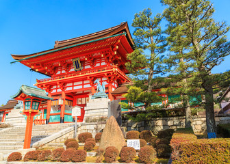 Fototapeta premium Ancient japanese wood gate and garden with blue sky, Kyoto, Japan