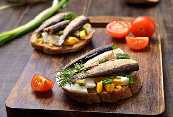 Sandwich with sprats, egg and green onion