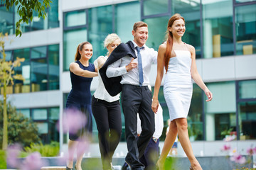 Four business people walking as a team