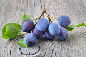 Fresh plums on the wooden table