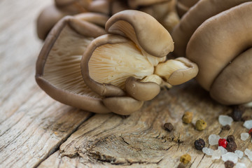 Fresh oyster mushrooms on wooden table. Shallow depth of field