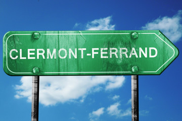 clermont-ferrand road sign, vintage green with clouds background