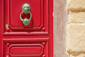 Lionhead doorknob and red door