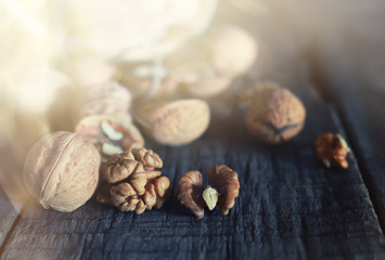 walnuts, whole and peeled wooden background