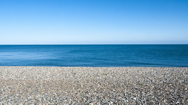 Seascape with pebble stone beach on a beautiful day in Llandudno Wales UK