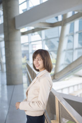 Fototapeta premium Attractive asian business woman smiling outside office