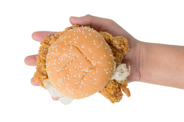 Hand holding a fried chicken burger isolate on white