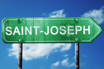 saint-joseph road sign, vintage green with clouds background