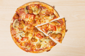 Pizza with sliced vegetables on wood