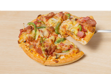Pizza with sliced vegetables on wood